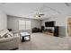 Spacious living room with carpet floors, ceiling fan, large window and entertainment center at 1569 Shannon Falls Dr, Fort Mill, SC 29715
