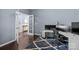 A well-lit office with stylish decor, including a modern desk, chair, and a blue patterned rug at 1569 Shannon Falls Dr, Fort Mill, SC 29715