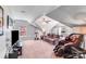 Large open carpeted bonus room featuring vaulted ceilings, a ceiling fan and a comfortable seating area at 15811 Burlingame Dr, Huntersville, NC 28078