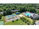 Aerial view showcasing community amenities including a pool, tennis courts and playground, with lush landscaping at 15811 Burlingame Dr, Huntersville, NC 28078