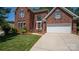Charming brick home with a well-manicured lawn and inviting entrance at 15811 Burlingame Dr, Huntersville, NC 28078