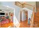 Bright foyer with hardwood floors, staircase, and natural light creating an open and inviting atmosphere at 15811 Burlingame Dr, Huntersville, NC 28078