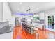 Well-lit kitchen featuring stainless steel appliances, island with seating, and granite countertops at 15811 Burlingame Dr, Huntersville, NC 28078