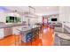 Spacious kitchen with stainless steel appliances, granite countertops, a center island with bar seating, and hardwood floors at 15811 Burlingame Dr, Huntersville, NC 28078