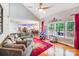Open concept living room with kitchen and dining area in view; large windows and comfortable seating at 15811 Burlingame Dr, Huntersville, NC 28078