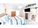Spacious main bedroom featuring a vaulted ceiling, ceiling fan, and an en suite bath with a sliding barn door at 15811 Burlingame Dr, Huntersville, NC 28078
