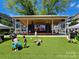 Exterior of an outdoor stage and lawn area for an event, surrounded by townhouses and greenery at 15811 Burlingame Dr, Huntersville, NC 28078