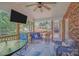 Covered screened porch with ceiling fan, outdoor seating, and view of the backyard at 15811 Burlingame Dr, Huntersville, NC 28078
