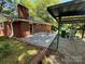 Outdoor patio area with table and chairs, next to covered structure at 211 S Slack St, Albemarle, NC 28001