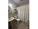 Functional bathroom with a pedestal sink, toilet, and shower with a white curtain at 211 S Slack St, Albemarle, NC 28001