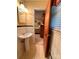 Bathroom featuring a pedestal sink and open door, offering a glimpse into the connected bedroom at 211 S Slack St, Albemarle, NC 28001