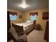 Cozy bedroom features a comfortable bed, chair, and natural light from two windows at 211 S Slack St, Albemarle, NC 28001