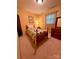 Charming bedroom with yellow walls, a quilt-covered bed, and vintage furniture at 211 S Slack St, Albemarle, NC 28001