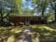 Charming brick ranch home with mature trees and a well-manicured lawn in a serene setting at 211 S Slack St, Albemarle, NC 28001
