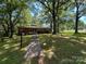 Charming single-story brick home with a well-manicured front yard and mature trees at 211 S Slack St, Albemarle, NC 28001
