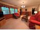 Cozy living room with carpeting and bright red sofas, and large windows at 211 S Slack St, Albemarle, NC 28001