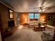 Cozy living room with brick fireplace, wood-paneled walls, and comfortable seating at 211 S Slack St, Albemarle, NC 28001