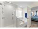 Bright bathroom featuring a tiled shower, soaking tub, and views into primary bedroom at 2439 Judson Dr, Gastonia, NC 28054