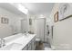 Modern bathroom featuring double sinks, tiled floors, and a shower-tub combination for a luxurious experience at 2439 Judson Dr, Gastonia, NC 28054