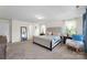 Large primary bedroom with neutral decor, soft carpet, and lots of natural light from several windows at 2439 Judson Dr, Gastonia, NC 28054