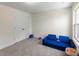 Well-lit bedroom featuring a cozy blue sofa, spacious layout, and ample storage at 2439 Judson Dr, Gastonia, NC 28054