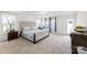 Expansive primary bedroom with a tufted headboard, lots of natural light, and neutral carpeting at 2439 Judson Dr, Gastonia, NC 28054