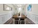 Bright dining room with a large wooden table, elegant wainscoting, and modern chandelier at 2439 Judson Dr, Gastonia, NC 28054