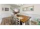 Elegant dining room featuring a long wooden table, stylish decor, and hardwood floors at 2439 Judson Dr, Gastonia, NC 28054