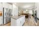 Open kitchen design with stainless steel appliances, white cabinetry, and a view into the dining and living areas at 2439 Judson Dr, Gastonia, NC 28054