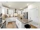 A well-lit kitchen featuring white cabinets, stainless steel appliances, and a functional kitchen island at 2439 Judson Dr, Gastonia, NC 28054