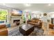 Open concept living room with modern fireplace, views of the kitchen and dining area, and lots of natural light at 2439 Judson Dr, Gastonia, NC 28054