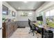 Bright home office with wainscotting, modern desk, and multiple windows for natural light at 2439 Judson Dr, Gastonia, NC 28054