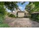 Rear view of a home surrounded by trees with a basketball hoop and an outdoor deck at 300 S Hudson Ave, Spencer, NC 28159