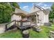 Outdoor deck area with grill, table, plants, and steps leading to the yard at 300 S Hudson Ave, Spencer, NC 28159