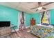 Bright bedroom features hardwood floor, ceiling fan, desk and chair setup, and plenty of natural light at 300 S Hudson Ave, Spencer, NC 28159