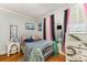 Bright bedroom features a twin bed, hardwood floors, and modern decor for a cozy aesthetic at 300 S Hudson Ave, Spencer, NC 28159