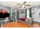 Bedroom includes a twin bed, ceiling fan, cat tower and wood floors at 300 S Hudson Ave, Spencer, NC 28159