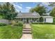 Charming home with a covered front porch, walkway and a well-manicured lawn at 300 S Hudson Ave, Spencer, NC 28159