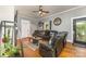 Inviting living room featuring hardwood floors, ceiling fan, and comfortable leather seating at 300 S Hudson Ave, Spencer, NC 28159