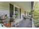Covered porch with seating, plants, and decor at 300 S Hudson Ave, Spencer, NC 28159