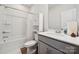 Well-lit bathroom showcasing a tub-shower combination, storage cabinet, and a modern vanity with a white countertop at 3115 Hutton Gardens Ln, Charlotte, NC 28269
