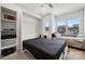 Bright bedroom with a built-in Murphy bed, shelving unit, and a large window providing ample natural light at 3115 Hutton Gardens Ln, Charlotte, NC 28269