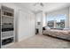 Bright bedroom with a built-in Murphy bed, shelving unit, and a large window providing ample natural light at 3115 Hutton Gardens Ln, Charlotte, NC 28269