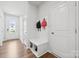 Bright foyer featuring coat rack with bench, storage, and attractive wood-look flooring at 3115 Hutton Gardens Ln, Charlotte, NC 28269