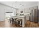 Modern kitchen with a large island, stainless steel appliances, and stylish pendant lighting at 3115 Hutton Gardens Ln, Charlotte, NC 28269