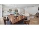 Stylish kitchen and dining area featuring stainless appliances, modern pendant lights, and hardwood flooring at 3115 Hutton Gardens Ln, Charlotte, NC 28269