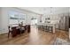 Modern kitchen with a large island, stainless steel appliances, and a dining area with backyard access at 3115 Hutton Gardens Ln, Charlotte, NC 28269