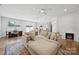 Spacious living area opens up to the kitchen, dining area, and features a modern fireplace at 3115 Hutton Gardens Ln, Charlotte, NC 28269