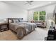 Spacious main bedroom with a large window, a cozy seating area, and neutral decor creating a relaxing atmosphere at 3115 Hutton Gardens Ln, Charlotte, NC 28269
