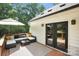 Enjoy this relaxing back deck with cushioned seating, a neutral outdoor rug, and adjacent access to inside through french doors at 316 Wade Hampton Dr, Matthews, NC 28104